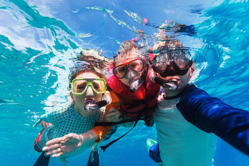 Underwater Adventure: Kids Snorkelling and Capturing a Fun Groupie Shot